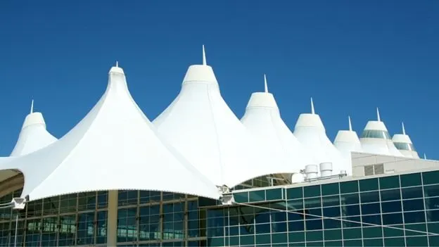 Denver International Airport terminal with white tent-shaped roof against a blue sky